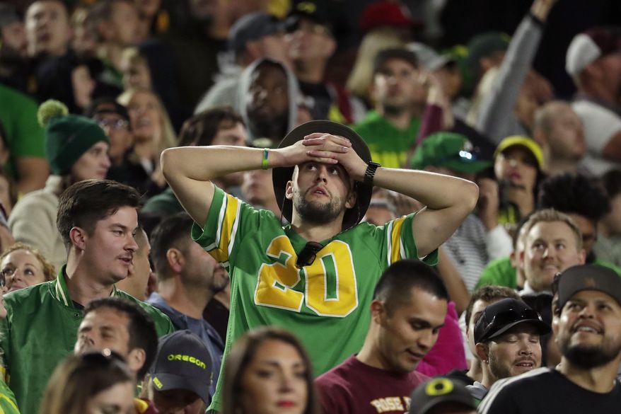 An Oregon fan reacts during the final seconds of the team's NCAA college football game against Arizona State, Saturday, Nov. 23, 2019, in Tempe, Ariz. Arizona State won 31-28. (AP Photo/Matt York)