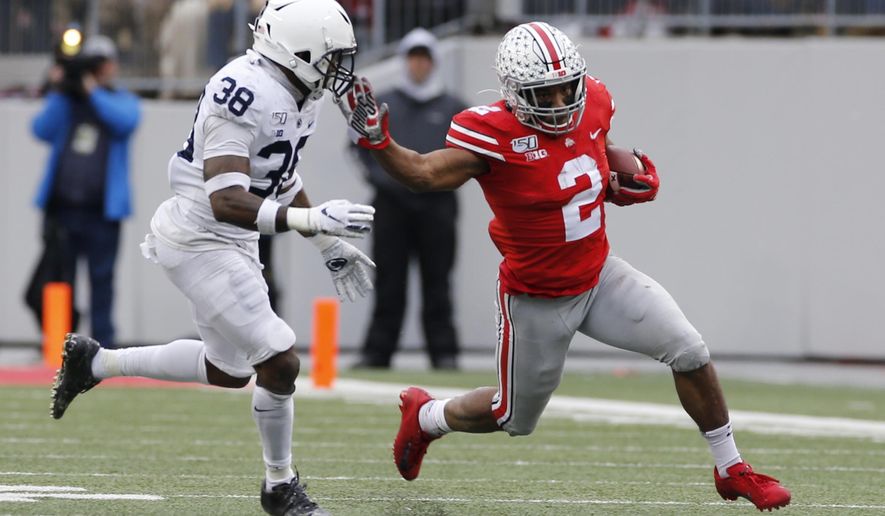 Ohio State running back J.K. Dobbins, right, cuts up field against Penn State defensive back Lamont Wade during the first half of an NCAA college football game Saturday, Nov. 23, 2019, in Columbus, Ohio. (AP Photo/Jay LaPrete)