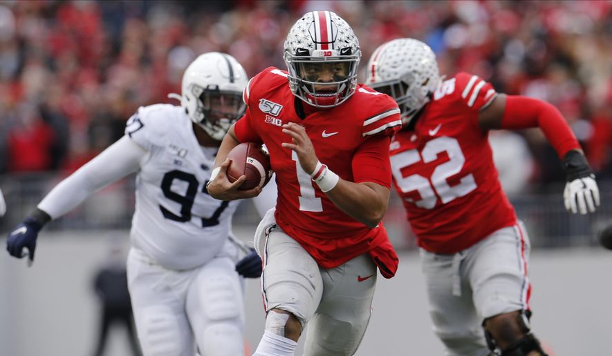 Ohio State quarterback Justin Fields, center, runs for a first down against Penn State during the first half of an NCAA college football game Saturday, Nov. 23, 2019, in Columbus, Ohio. (AP Photo/Jay LaPrete) **FILE**