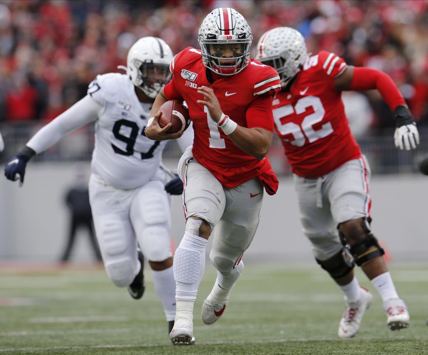 Ohio State quarterback Justin Fields, center, runs for a first down against Penn State during the first half of an NCAA college football game Saturday, Nov. 23, 2019, in Columbus, Ohio. (AP Photo/Jay LaPrete) **FILE**