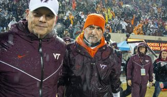 Virginia Tech head coach Justin Fuente and defensive coordinator Bud Foster take the field after shutting out Pittsburgh 28-0 after an NCAA college football game in Blacksburg, Va., Saturday, Nov. 23, 2019. (AP Photo/Matt Bell)