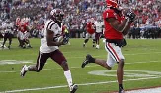 Georgia wide receiver George Pickens (1) makes a catch for a touchdown as Texas A&amp;amp;M defensive back Debione Renfro (29) defends in the first half of an NCAA college football game Saturday, Nov. 23, 2019, in Athens, Ga. (AP Photo/John Bazemore)