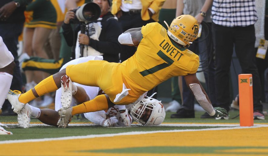 Baylor running back John Lovett (7) falls backward into the end zone for a touchdown against Texas in an NCAA college football game Saturday, Nov. 23, 2019, in Waco, Texas. (AP Photo/Richard W. Rodriguez)