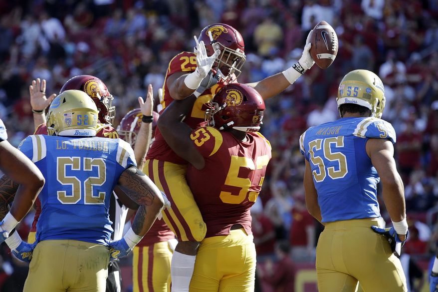 Southern California running back Vavae Malepeai (29) celebrates his rushing touchdown with linebacker Bryce Matthews (53) during the first half of an NCAA college football game against UCLA, Saturday, Nov. 23, 2019, in Los Angeles. (AP Photo/Marcio Jose Sanchez)