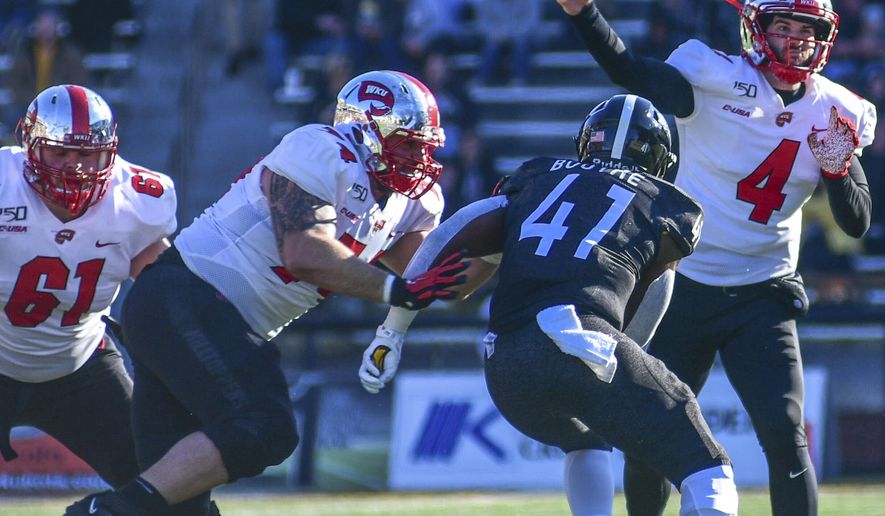 Western Kentucky quarterback Ty Storey (4) makes a pass against Southern Mississippi during an NCAA college football game, Saturday, Nov. 23, 2019. (Cam Bonelli/Hattiesburg American via AP)