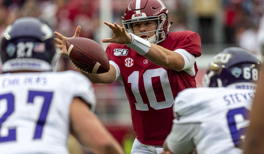 Alabama quarterback Mac Jones (10) grabs a wide snap from the shotgun position during the first half of an NCAA college football game against Western Carolina, Saturday, Nov. 23, 2019, in Tuscaloosa, Ala. (AP Photo/Vasha Hunt)