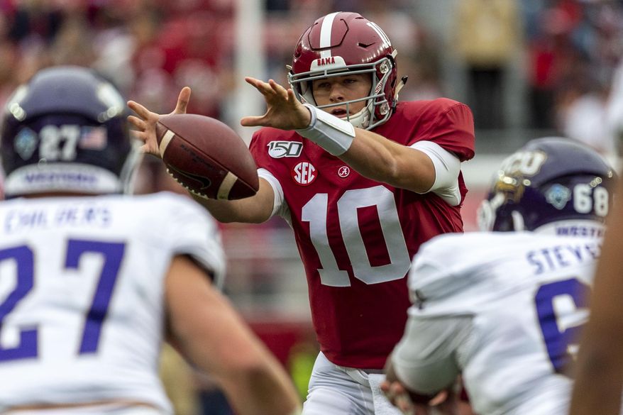Alabama quarterback Mac Jones (10) grabs a wide snap from the shotgun position during the first half of an NCAA college football game against Western Carolina, Saturday, Nov. 23, 2019, in Tuscaloosa, Ala. (AP Photo/Vasha Hunt)
