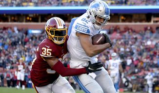 Detroit Lions tight end Logan Thomas (82) scores a touchdown on a pass from quarterback Jeff Driskel, not visible, as Washington Redskins free safety Montae Nicholson (35) tries to bring him down in the end zone during the second half of an NFL football game, Sunday, Nov. 24, 2019, in Landover, Md. (AP Photo/Alex Brandon) ** FILE **
