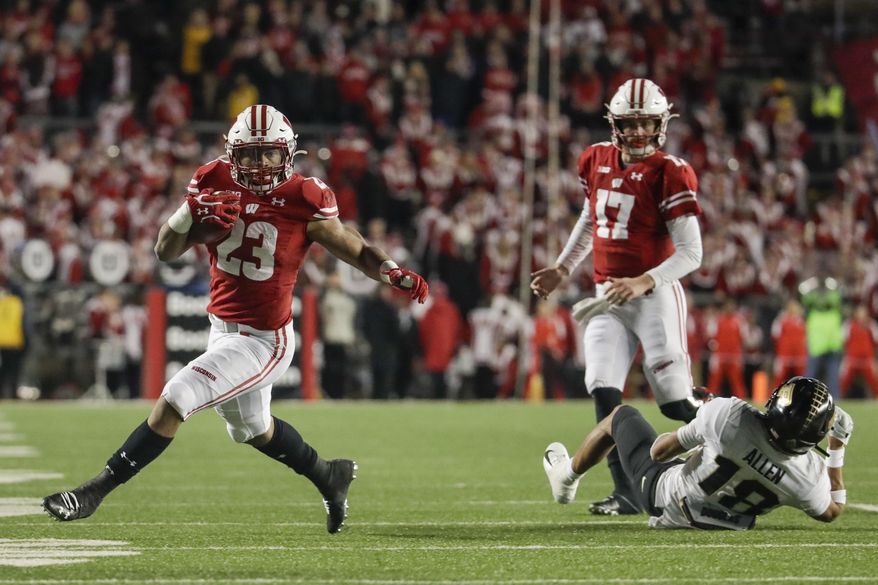 Wisconsin's Jonathan Taylor runs during the second half of an NCAA college football game against Purdue Saturday, Nov. 23, 2019, in Madison, Wis. (AP Photo/Morry Gash)