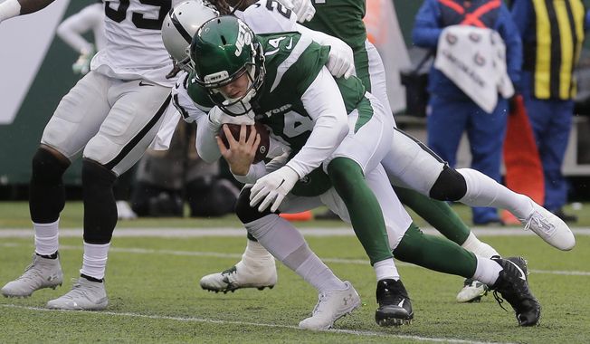 New York Jets quarterback Sam Darnold (14) runs past Oakland Raiders&#x27; D.J. Swearinger (21) for a touchdown during the first half of an NFL football game Sunday, Nov. 24, 2019, in East Rutherford, N.J. (AP Photo/Seth Wenig)