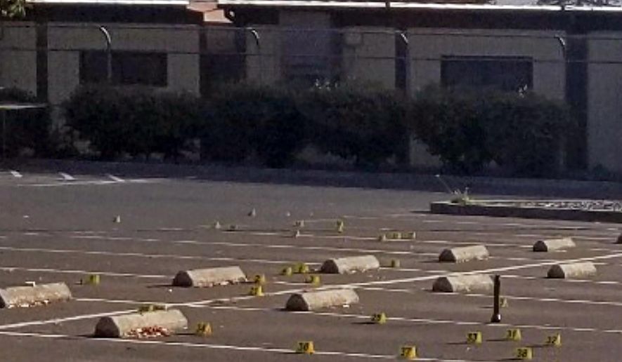 This Saturday, Nov. 23, 2019, photo released by the Union City Police Department shows crime scene evidence markers at the parking lot of the Searles Elementary School in Union City, Calif. Police say a deadly shootings of teenage boys took place early Saturday morning in the parking lot. Authorities say that when officers arrived, they found the boys. (Union City Police Department via AP)