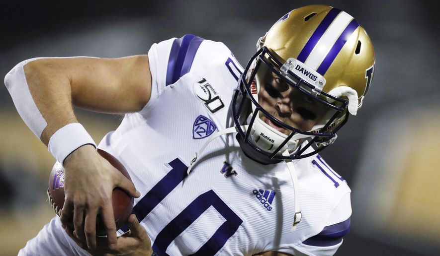Washington quarterback Jacob Eason catches a pass as he warms up for the team's NCAA college football game against Colorado on Saturday, Nov. 23, 2019, in Boulder, Colo. (AP Photo/David Zalubowski)