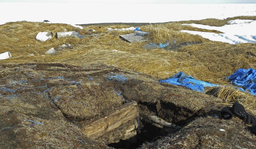 This May 3, 2009, photo taken in Point Hope, Alaska, provided by the Alaska Native Tribal Health Consortium, shows the entrance to an ice cellar, a type of underground food dug into the permafrost to provide natural refrigeration used for generations in far-north communities. Naturally cooled underground ice cellars, used in Alaska Native communities for generations, are becoming increasingly unreliable as a warming climate and other factors touch multiple facets of life in the far north. (Mike Brubaker/Alaska Native Tribal Health Consortium via AP)