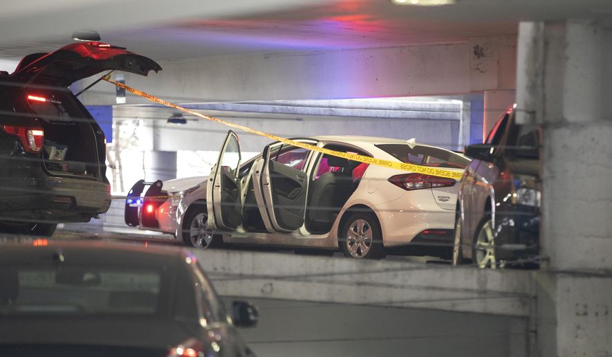 A white vehicle is parked at the scene of a death investigation in a University of Illinois at Chicago parking garage Saturday, Nov. 23, 2019, in Chicago. Authorities say the body of a missing University of Illinois at Chicago student has been found in a car inside campus parking garage.The Cook County medical examiner identified the woman found Saturday as 19-year-old Ruth George of Berwyn. (Erin Hooley/Chicago Tribune via AP)