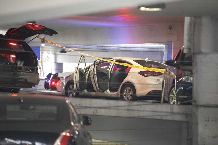 A white vehicle is parked at the scene of a death investigation in a University of Illinois at Chicago parking garage Saturday, Nov. 23, 2019, in Chicago. Authorities say the body of a missing University of Illinois at Chicago student has been found in a car inside campus parking garage.The Cook County medical examiner identified the woman found Saturday as 19-year-old Ruth George of Berwyn. (Erin Hooley/Chicago Tribune via AP)