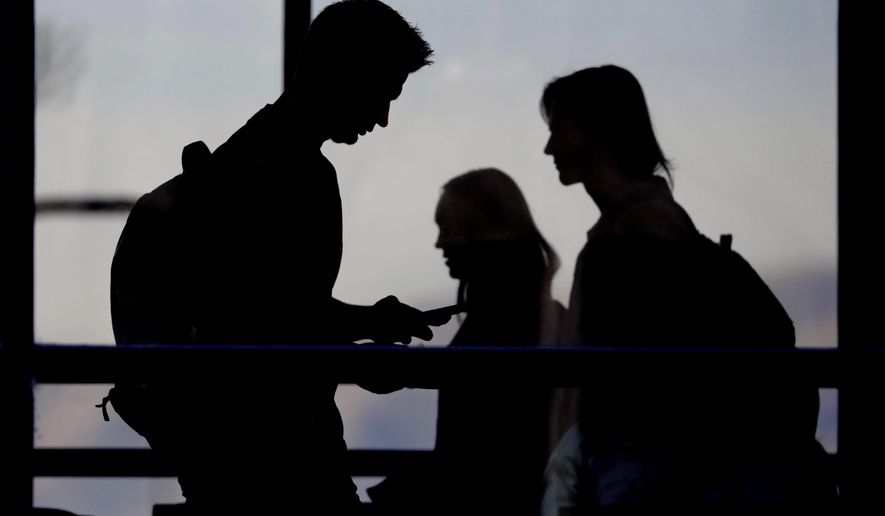 In this Nov. 14, 2019, photo, students walk on the campus of Utah Valley University in Orem, Utah. More college students are turning to their schools for help with anxiety, depression and other mental health problems. That's according to an Associated Press review of more than three dozen public universities. (AP Photo/Rick Bowmer)