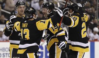 Pittsburgh Penguins&#39; Jared McCann (19) celebrates after scoring during the second period of an NHL hockey game against the Calgary Flames in Pittsburgh, Monday, Nov. 25, 2019. (AP Photo/Gene J. Puskar)