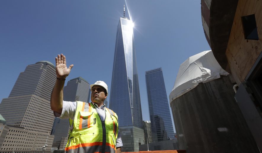 FILE - In this Aug. 10, 2017 file photo, Jerome Dimitriou, executive director of the Greek Orthodox Archdiocese of America, describes the construction progress at the St. Nicholas National Shrine, right, in New York. Dimitriou was arrested Monday, Nov. 25, 2019, on charges of embezzling nearly half a million dollars from the organization. (AP Photo/Mark Lennihan, File)