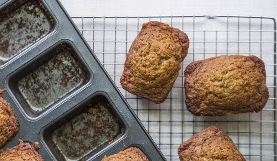 This September 2017 photo taken in New York shows mini banana bread. Setting out breakfast for your guests to help themselves when they wake up in the morning is a low-stress, make ahead way for you to offer the morning meal. (Sarah Crowder/Katie Workman via AP)