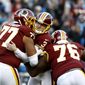 Washington Redskins kicker Dustin Hopkins, center, is mobbed by offensive guard Ereck Flowers (77) and offensive tackle Morgan Moses (76) after kicking the eventual game-winning field goal in the final seconds of the second half of an NFL football game against the Detroit Lions, Sunday, Nov. 24, 2019, in Landover, Md. The Redskins won 19-16. (AP Photo/Patrick Semansky) ** FILE **