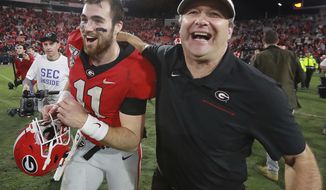 Georgia head coach Kirby Smart and quarterback Jake Fromm celebrate beating Texas A&amp;amp;M 19-13 in an NCAA college football game Saturday, Nov. 23, 2019, in Athens, Ga. (Curtis Compton/Atlanta Journal-Constitution via AP)