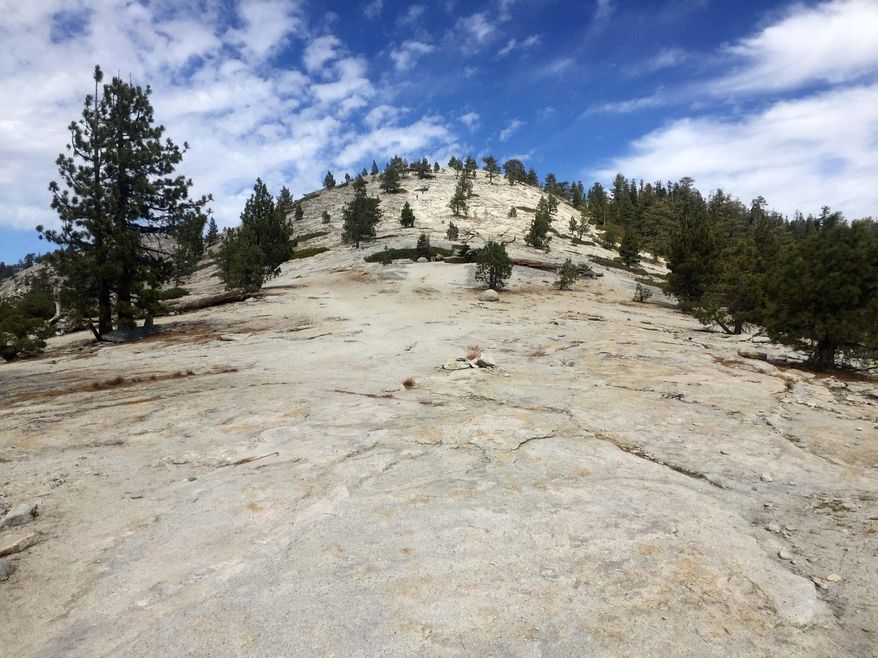 This Sept. 29, 2018 photo shows an ascending view of Yosemite National Park’s North Dome, which provides jaw-dropping views of the more famous Half Dome. (AP Photo/Amanda Lee Myers)