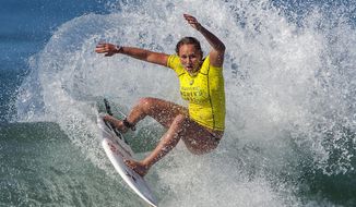 FILE - In this Sept. 9, 2014, file photo, Carissa Moore surfs during round one of the Swatch Women&#39;s Pro Trestles surfing competition in San Clemente, Calif. Moore is one of three Americans that will be surfing for their country’s two Olympic berths as well as the world championship at the Lululemon Maui Pro. (Mark Rightmire/The Orange County Register via AP, File)