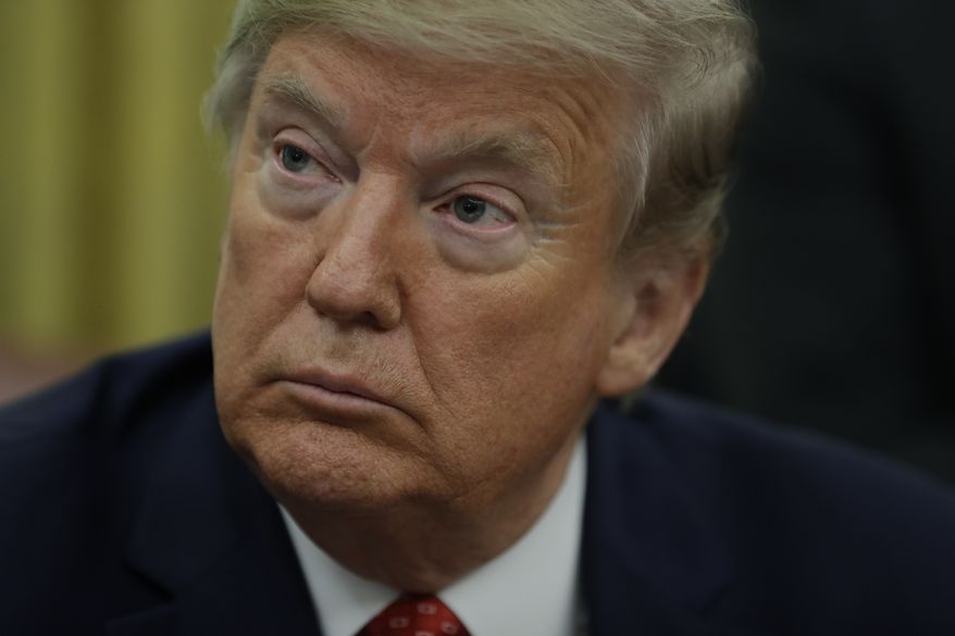 President Donald Trump signs an executive order establishing the Task Force on Missing and Murdered American Indians and Alaska Natives, in the Oval Office of the White House, Tuesday, Nov. 26, 2019, in Washington. (AP Photo/ Evan Vucci)