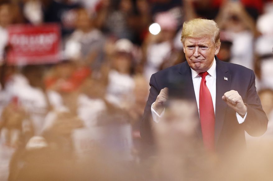 President Donald Trump reacts to the crowd before he speaks during a rally on Tuesday, Nov. 26, 2019, in Sunrise, Fla. (AP Photo/Brynn Anderson)