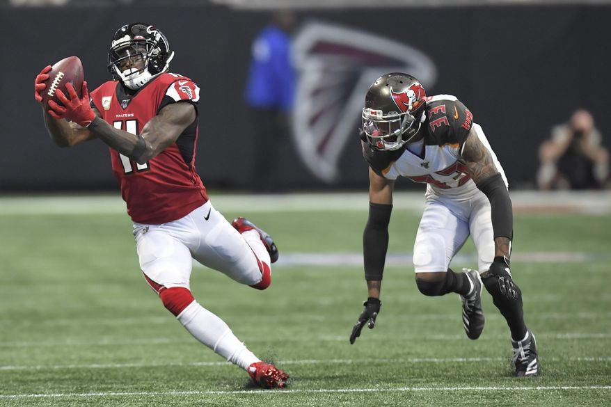 Atlanta Falcons wide receiver Julio Jones (11) makes the catch against Tampa Bay Buccaneers cornerback Carlton Davis (33) during the first half of an NFL football game, Sunday, Nov. 24, 2019, in Atlanta. (AP Photo/Danny Karnik)