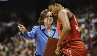 FILE - In this Aug. 10, 2014, file photo, Washington Mystics&#39; assistant coach Marianne Stanley, left, talks with player Kia Vaughn during the first half of a WNBA basketball game, in Uncasville, Conn. The Indiana Fever has hired Marianne Stanley as its new head coach. Stanley had been an assistant with the Washington Mystics since 2010 and was part of last season’s WNBA championship run. She was named the 2002 WNBA coach of the year with Washington and has served as an assistant with the Los Angeles Sparks and New York Liberty.(AP Photo/Jessica Hill) ** FILE **