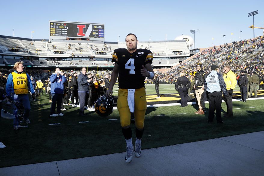 Iowa quarterback Nate Stanley runs off the field after an NCAA college football game against Illinois, Saturday, Nov. 23, 2019, in Iowa City, Iowa. Iowa won 19-10. (AP Photo/Charlie Neibergall)