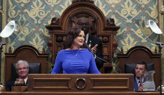 FILE - In this Feb. 12, 2019 file photo, Michigan Gov. Gretchen Whitmer delivers her State of the State address to a joint session of the House and Senate as Senate Majority Leader Mike Shirkey, House Speaker Lee Chatfield, right, and Lt. Gov. Garlin Gilchrist, rear, react, at the state Capitol in Lansing, Mich. A budget impasse in Michigan is starting to take a toll on government programs and services. Nearly two months ago, Democratic Gov. Whitmer vetoed an unprecedented $947 million in funding to restart broken-down budget talks. She and the Republican-led Legislature want to reverse some or many of her vetoes. But they remain at odds over Republicans’ push to curtail her powers after the first-year governor shifted funding within state departments. (AP Photo/Al Goldis File)