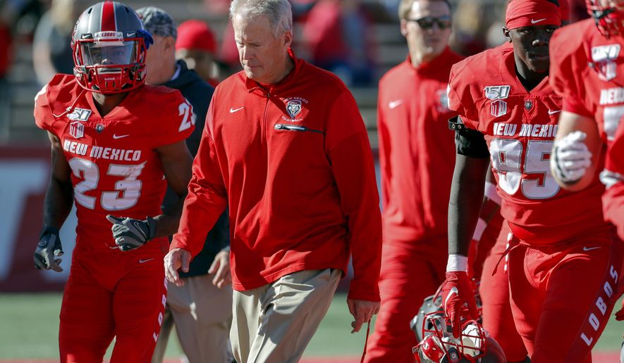 FILE - In this Saturday, Oct. 26, 2019, file photo, New Mexico coach Bob Davie leads his team from the field at halftime of an NCAA college football game against Hawaii in Albuquerque, N.M. On Monday, Nov. 25, Davie agreed to step aside as New Mexico’s coach at the end of the season, ending an uneven eight-season tenure with the Lobos. (AP Photo/Andres Leighton, File)