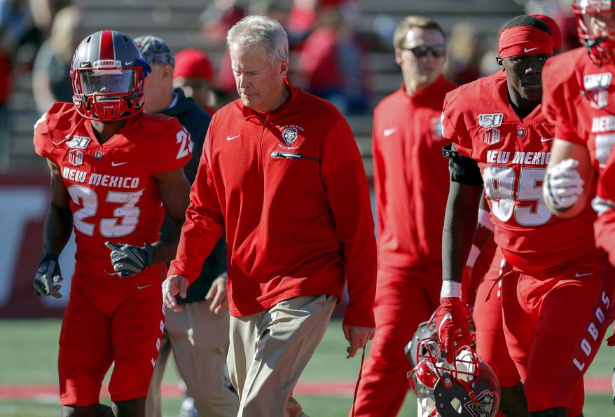 FILE - In this Saturday, Oct. 26, 2019, file photo, New Mexico coach Bob Davie leads his team from the field at halftime of an NCAA college football game against Hawaii in Albuquerque, N.M. On Monday, Nov. 25, Davie agreed to step aside as New Mexico’s coach at the end of the season, ending an uneven eight-season tenure with the Lobos. (AP Photo/Andres Leighton, File)