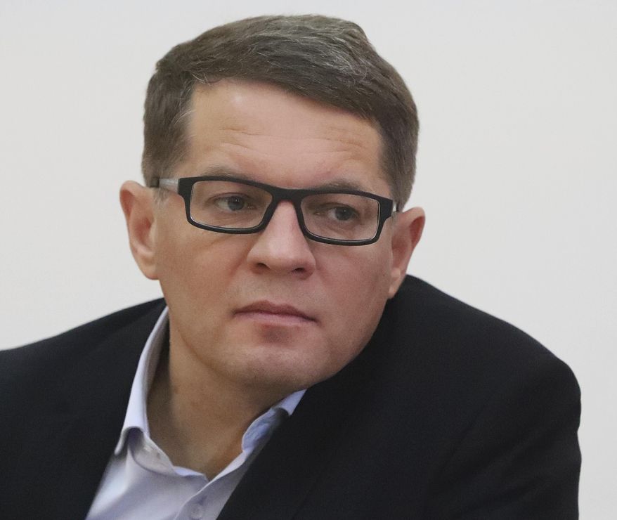 Roman Sushchenko, a Ukrainian journalist who spent three years in a Russian prison on spying charges, speaks to reporters to described how he would create paintings of cathedrals and other scenes as a way of surviving his imprisonment at a news conference in Warsaw, Poland, Tuesday, Nov. 26, 2019. The Association of Polish Journalists is exhibiting reproductions of his works. (AP Photo/Czarek Sokolowski)