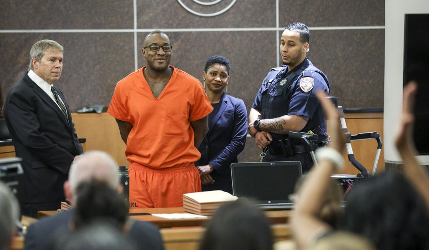 Lydell Grant, second from left, smiles in court after he was ordered to be released on bond on Tuesday, Nov. 26, 2019, in Houston. Prosecutors and defense attorneys with the Innocence Project of Texas agreed that Grant should be released while the case is investigated further in the light of new DNA evidence. Grant had been convicted of capital murder in the 2010 stabbing death of Aaron Scheerhoorn outside of a Montrose bar. ( Jon Shapley/Houston Chronicle via AP)
