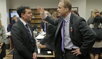 Tim Eyman, right, a career anti-tax initiative promoter, argues with Noah Purcell, left, Solicitor General of the State of Washington, following a King County Superior Court hearing, Tuesday, Nov. 26, 2019, in Seattle. Lawyers for cities and counties across Washington state were in court to ask King County Judge Marshall Ferguson to block Eyman&#39;s $30 I-976 car tab measure from taking effect, saying it was misleading and violates Washington&#39;s Constitution. (AP Photo/Ted S. Warren)