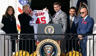Nationals first baseman Ryan Zimmerman, joined by First Lady Melania Trump, Nationals Manager Dave Martinez and Nationals General Manager Mike Rizzo, presents President Donald J. Trump with a Nationals jersey on the Blue Room Balcony of the White House Monday, Nov. 4, 2019, during the celebration of the 2019 World Series Champions, the Washington Nationals on the South Lawn. (Official White House Photo by Andrea Hanks) ** FILE **