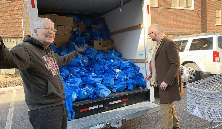 Mark Andersen (left) prepares to deliver a truckload of Thanksgiving turkeys to elderly residents in Northwest on Tuesday, Nov. 26, 2018. Mr. Andersen is the co-director of We Are Family, a nonprofit volunteer group. Photo by Sophie Kaplan / The Washington Times