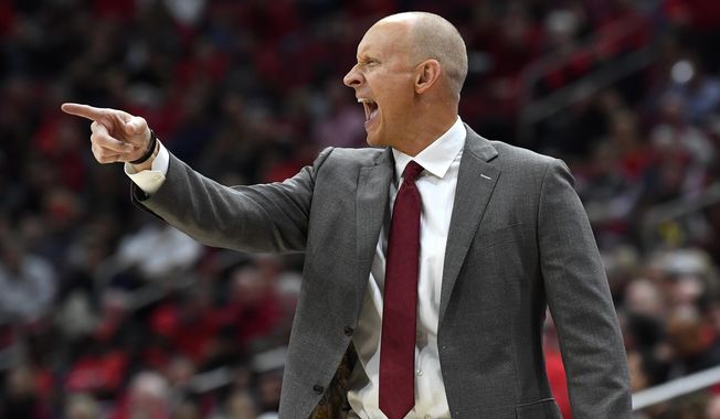 Louisville head coach Chris Mack shouts instructions to his players during the second half of an NCAA college basketball game against Akron in Louisville, Ky., Sunday, Nov. 24, 2019. (AP Photo/Timothy D. Easley)