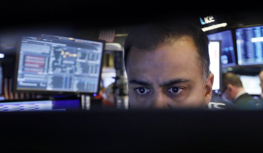 FILE - In this Nov. 20, 2019, file photo specialist Dilip Patel watches the screens at his post on the floor of the New York Stock Exchange. The U.S. stock market opens at 9:30 a.m. EST on Wednesday, Nov 27. (AP Photo/Richard Drew, File)