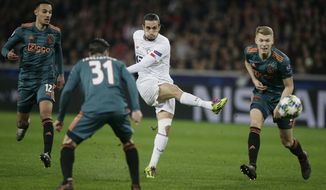 Lille&#39;s Yusuf Yazici, 2nd right, kicks the ball while Ajax&#39;s Noussair Mazraoui, left, Ajax&#39;s Nicolas Tagliafico, 2nd left, and Ajax&#39;s Perr Schuurs looks on during the group H Champions League soccer match between LOSC Lille and Ajax at the Stade Pierre Mauroy - Villeneuve d&#39;Ascq stadium in Lille, France, Wednesday, Nov. 27, 2019. (AP Photo/Michel Spingler)