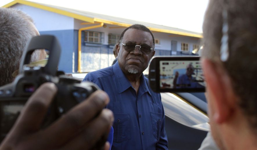 Namibian President Hage Geingob arrives to cast his vote in Windhoek, Namibia in the country's elections Wednesday, Nov. 27, 2019. Geingob's ruling party faces its biggest challenge since independence nearly three decades ago. The resource-rich southern African nation's registered 1.3 million voters are voting for president and National Assembly members. (AP Photo/Brandon van Wyk)