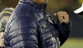 Navy head coach Ken Niumatalolo reacts after his team drew the SMU defense offsides on a fourth-down play to secure the victory during an NCAA college football game, Saturday, Nov. 23, 2019, in Annapolis, Md. Navy won 35-28. (AP Photo/Julio Cortez)