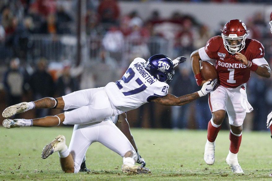 Oklahoma quarterback Jalen Hurts (1) avoids an attempted tackle by TCU safety Ar'Darius Washington (27) and linebacker Garret Wallow during an NCAA college football game Saturday, Nov. 23, 2019, in Norman, Okla. (Ian Maule/Tulsa World via AP)