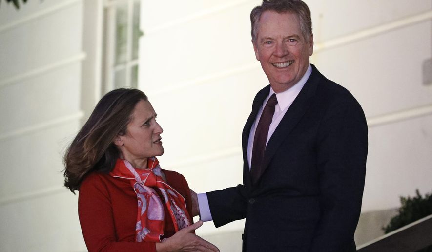 Canadian Deputy Prime Minister Chrystia Freeland, left, is welcomed by U.S. Trade Representative Robert Lighthizer as she arrives at the U.S. Trade Representative's office for talks on the U.S.-Mexico-Canada agreement on trade, Wednesday, Nov. 27, 2019, in Washington. (AP Photo/Patrick Semansky)