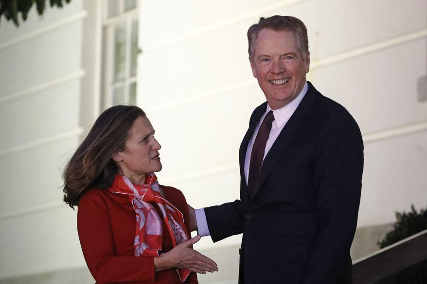 Canadian Deputy Prime Minister Chrystia Freeland, left, is welcomed by U.S. Trade Representative Robert Lighthizer as she arrives at the U.S. Trade Representative's office for talks on the U.S.-Mexico-Canada agreement on trade, Wednesday, Nov. 27, 2019, in Washington. (AP Photo/Patrick Semansky)