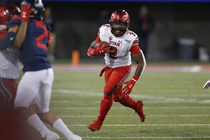 Utah running back Zack Moss (2) scores a touchdown against Arizona during the second half during an NCAA college football game, Saturday, Nov. 23, 2019, in Tucson, Ariz. (AP Photo/Rick Scuteri)