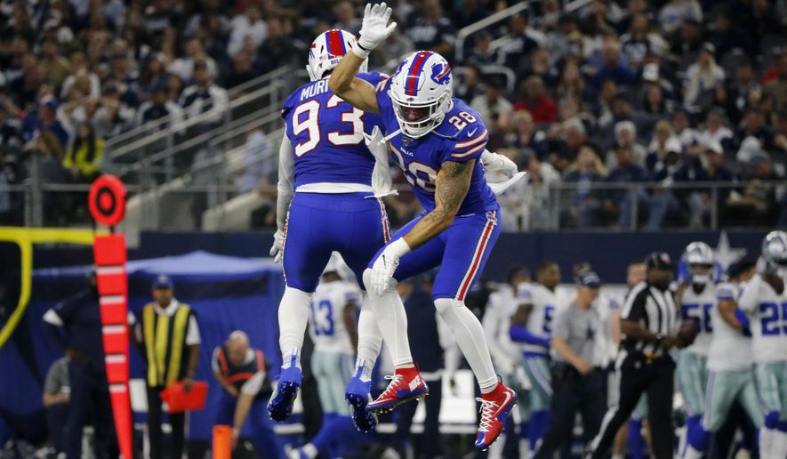 Buffalo Bills' Trent Murphy (93) and Kurt Coleman (28) celebrate a Dallas Cowboys quarterback Dak Prescott (4) fumble recovered by Murphy in the first half of an NFL football game in Arlington, Texas, Thursday, Nov. 28, 2019. (AP Photo/Michael Ainsworth)